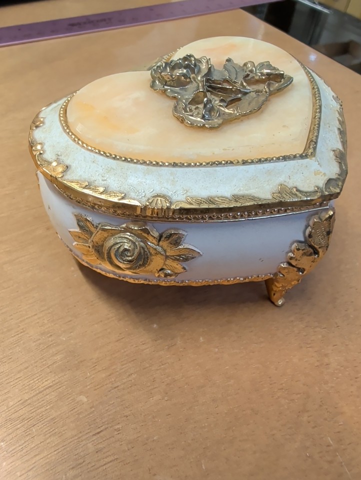 A gold-tone, heart-shaped Sankyo music box from Japan with rose detailing — sweet, sentimental, and the definition of charming vintage kitsch.