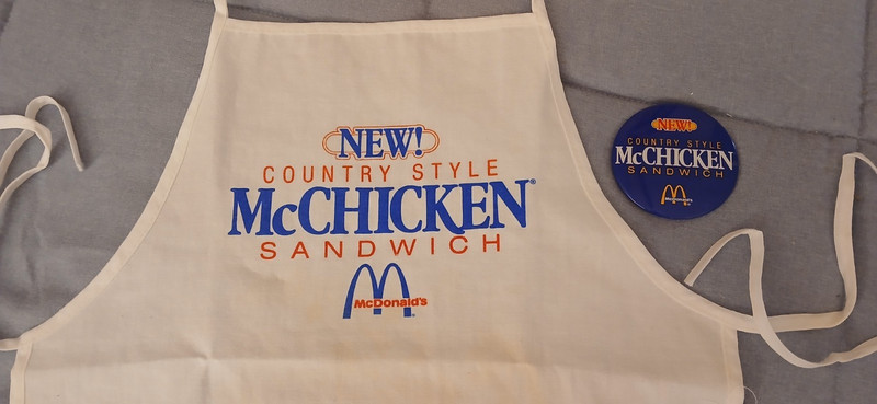 1988 McDonalds Country Style McChicken employee promo items: apron, button pin 