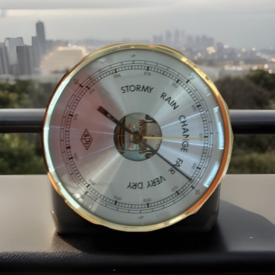 A collectible glimpse of an antique aneroid barometer.