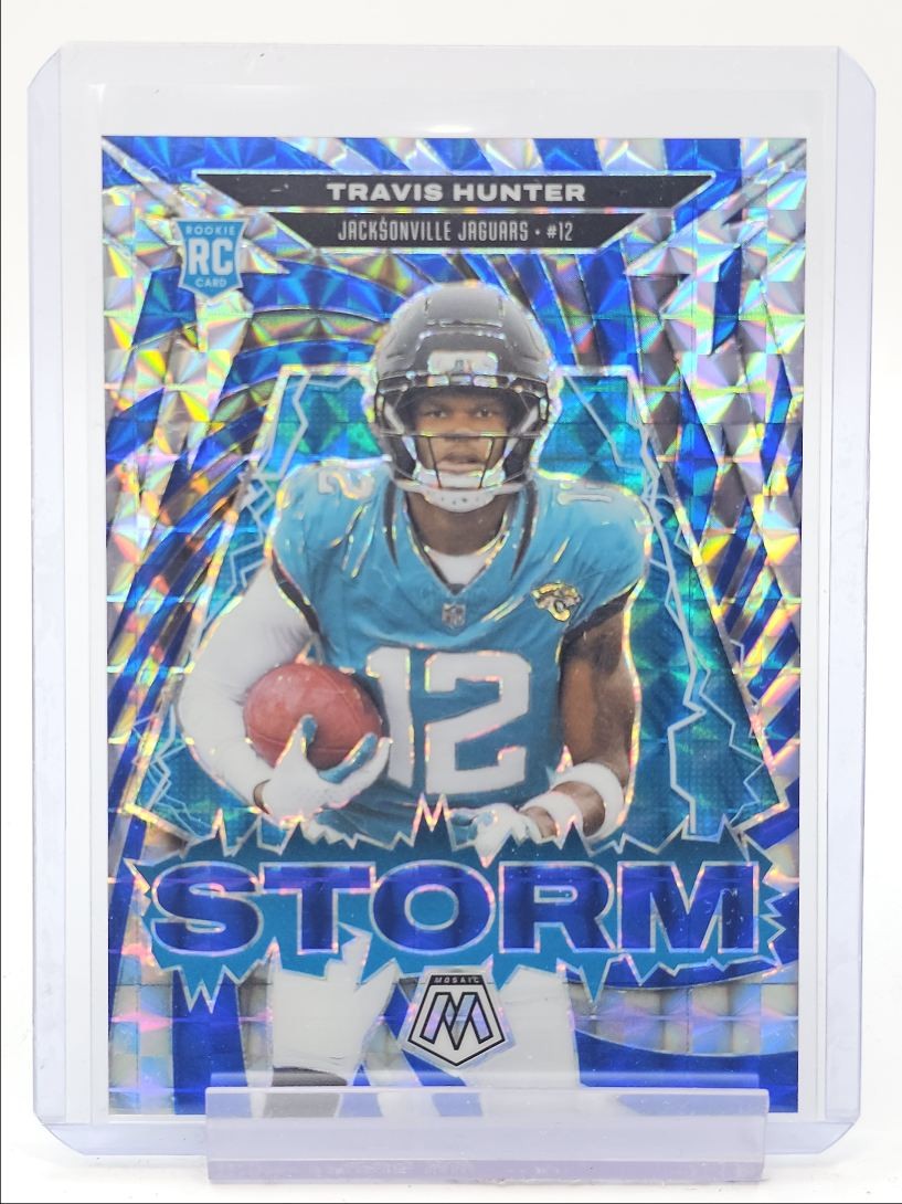 TRAVIS HUNTER 2025 MOSAIC STORM ROOKIE BLUE MOSAIC PRIZM RC /99 Q6145