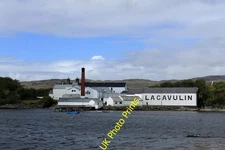 Photo 12x8 Lagavulin Distillery Lagavulin white on the shore with the name c2015