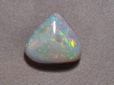 6.45 ct.  White Opal with a dark back ,  Pastel colors