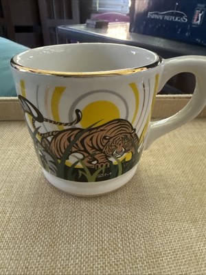 What embossed with gold trim tiger s on a 15 ounce mug