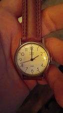 vintage 1990s Timex Quartz wristwatch features a cream-colored dial with distinc