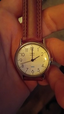 vintage 1990s Timex Quartz wristwatch features a cream-colored dial with distinc