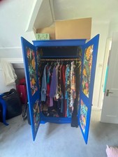 Upcycled wardrobe in bright blue, 2 doors, one shelf, with floral paper details 