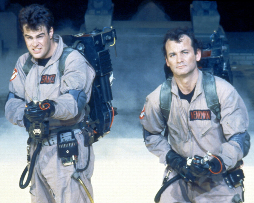 Dan Aykroyd and Bill Murray in Ghostbusters with smoke and guns