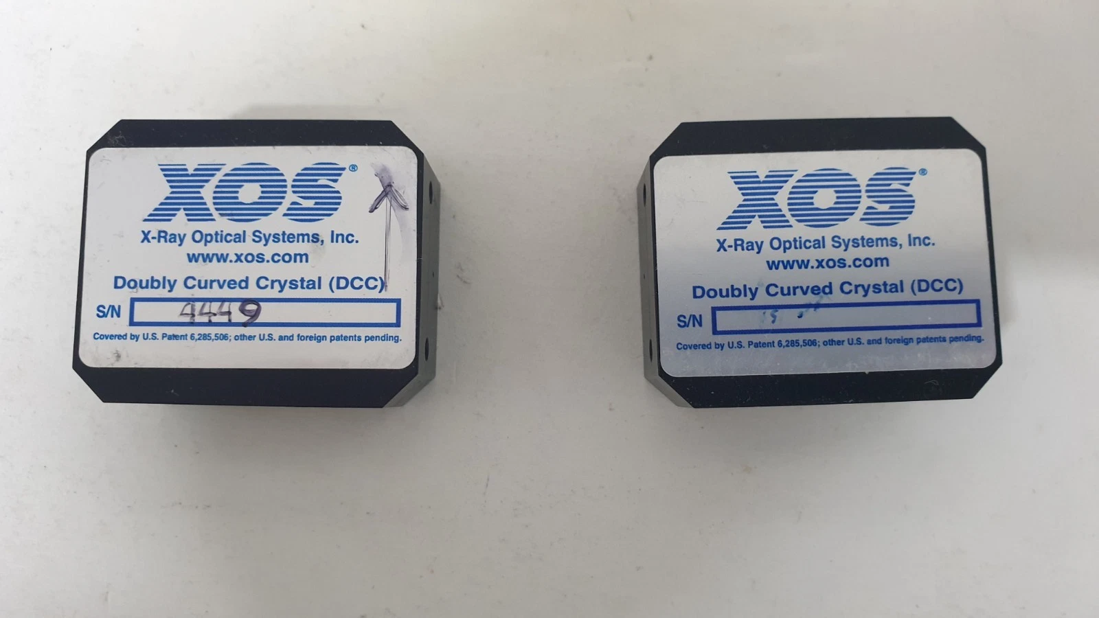 XOS X-Ray Optical Systems Doubly Curved Crystal (DCC) labels on the two optics