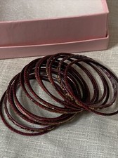 stack of red metal Girl s bangle bracelets set of 17