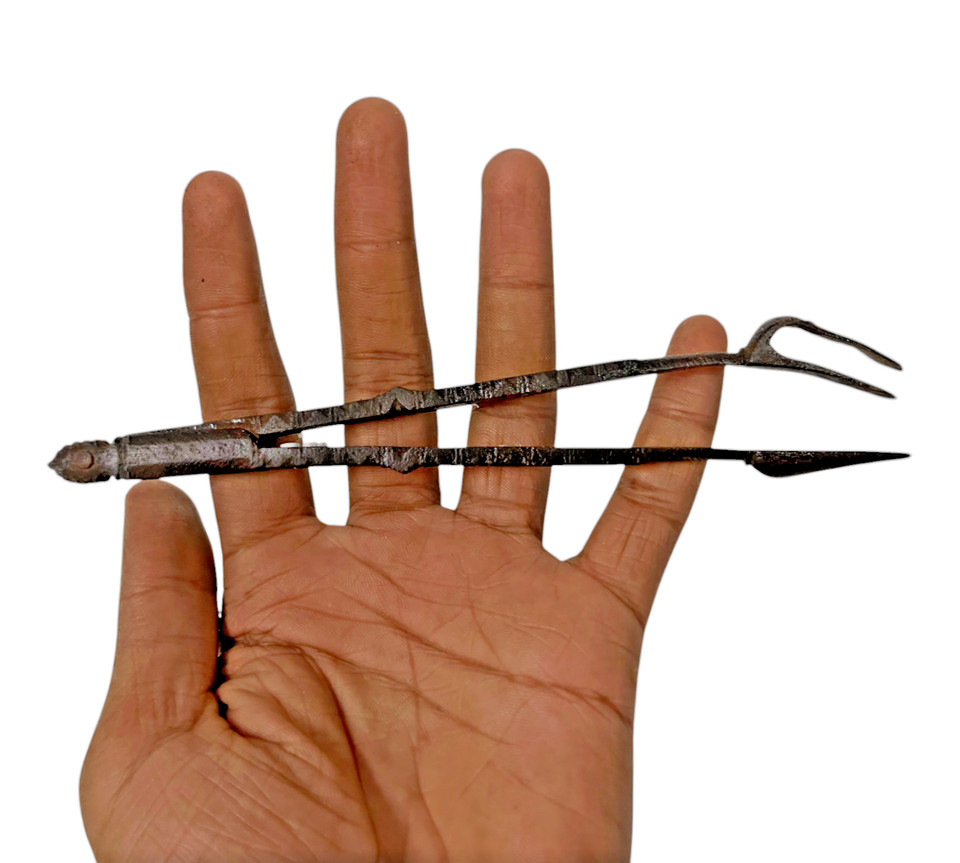 A hand-carved antique iron multi-tool that doubles as a conversation piece — the kind of object that makes people stop and ask 'what IS that?'