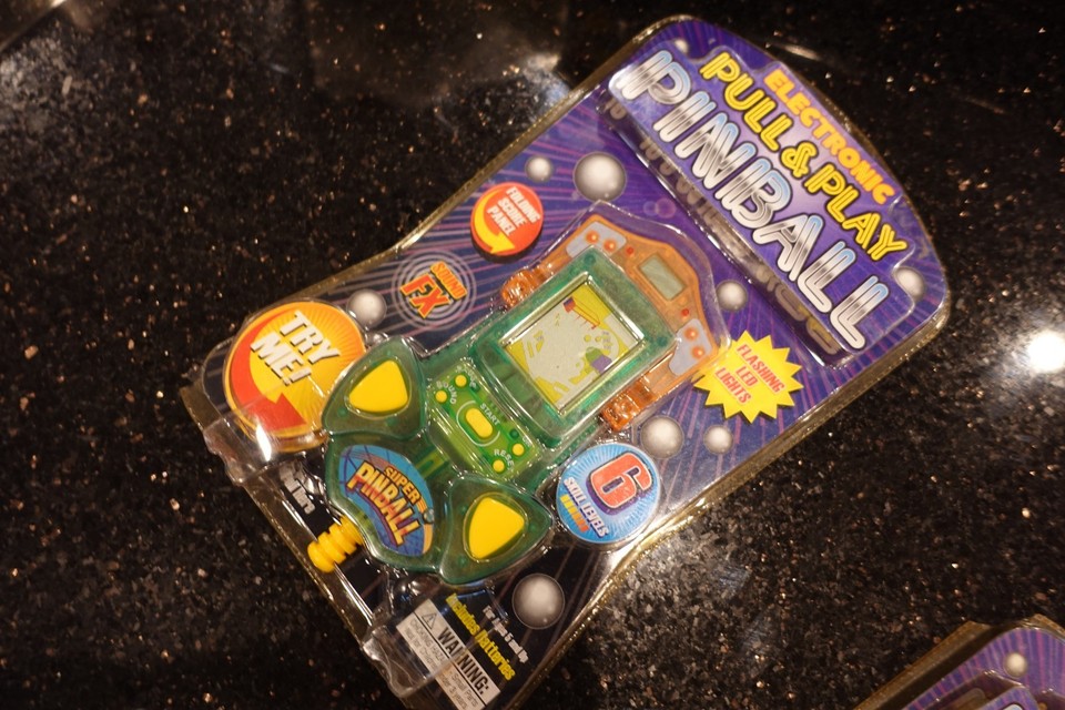A new-old-stock vintage green pinball tabletop electronic game — the kind of chunky, beeping, LED-lit handheld that defined cool in the late 70s/early 80s and looks amazing on a shelf.
