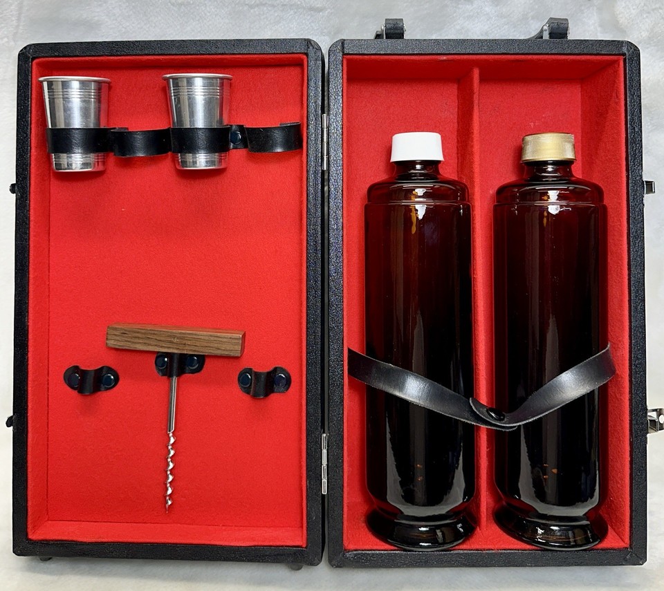 A mid-century portable travel bar in a fitted case — two bottles, two shot glasses, and maximum James Bond energy.