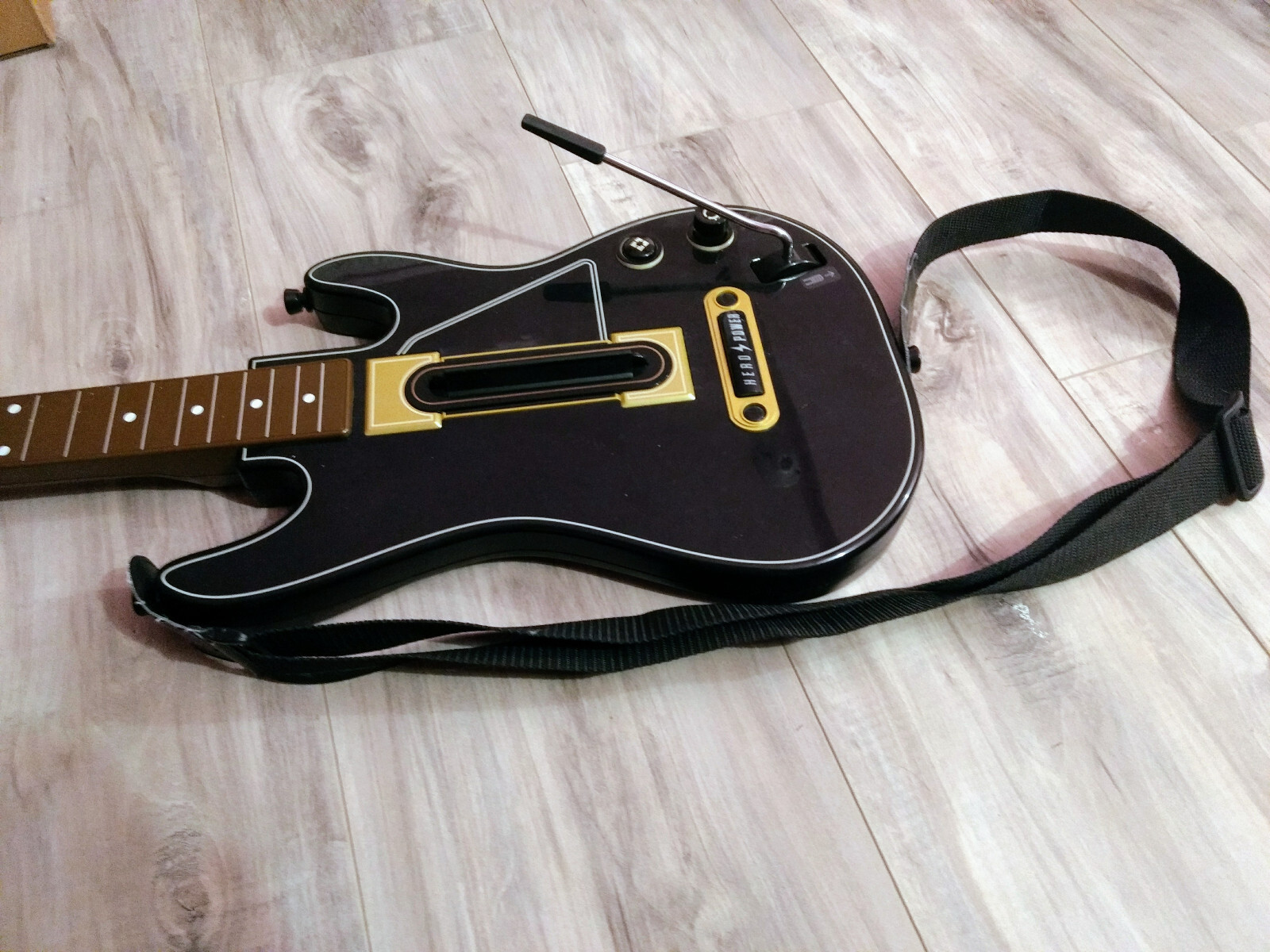 Used black Guitar Hero controller Hero Power Guitar Model 0000654. No