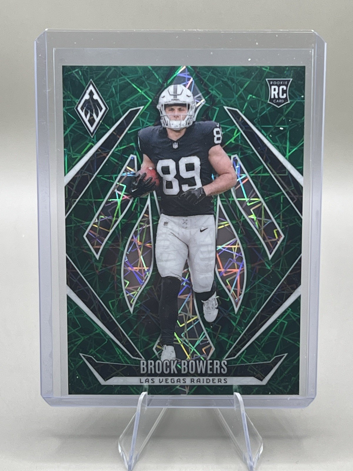 2024 Panini Phoenix - Rookies Brock Bowers #165 Green Lazer /50 (RC)