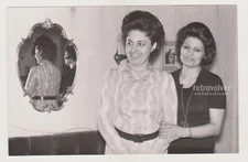 Two Lovely Ladies Arm in Arm Reflected in the Mirror Behind Them on Wall Photo