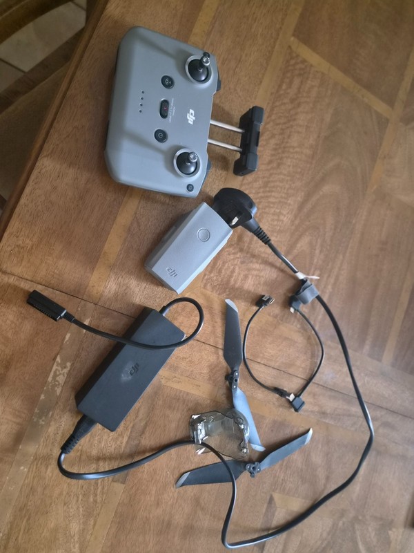 Mavic air 2 drone parts including controller, battery charger, battery.
