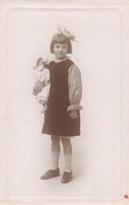 Young Girl With Bow In Hair Holding A Doll Studio Postcard