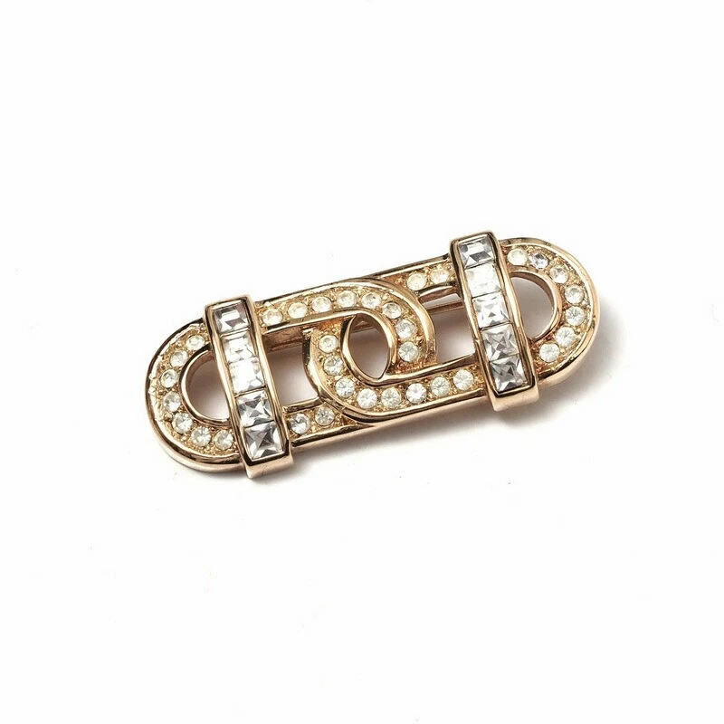 Broche ancienne Dior pavée cristal chrétienne dorée occasion usure liée à l'âge