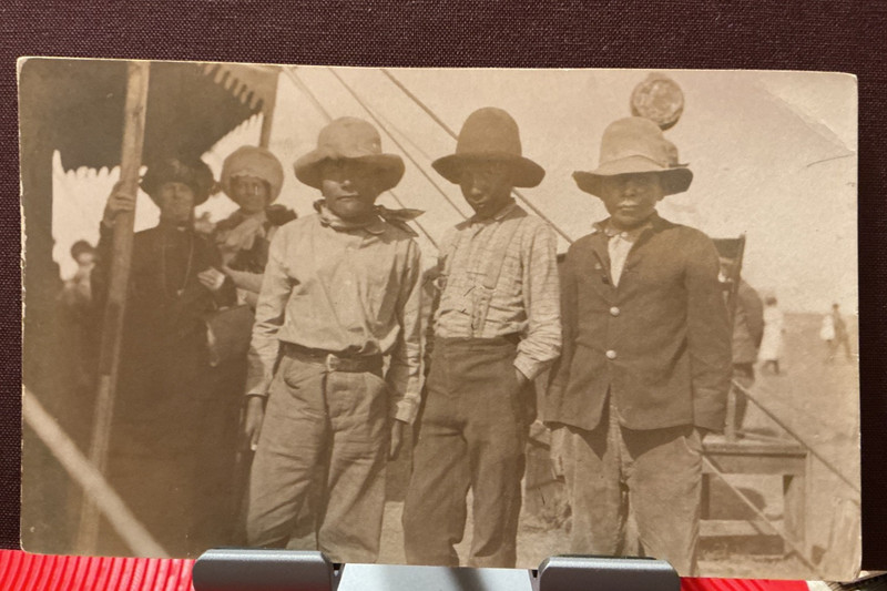 Early RPPC ~ Three Young Native American Indian Boys Posing w/ Women in the Rear