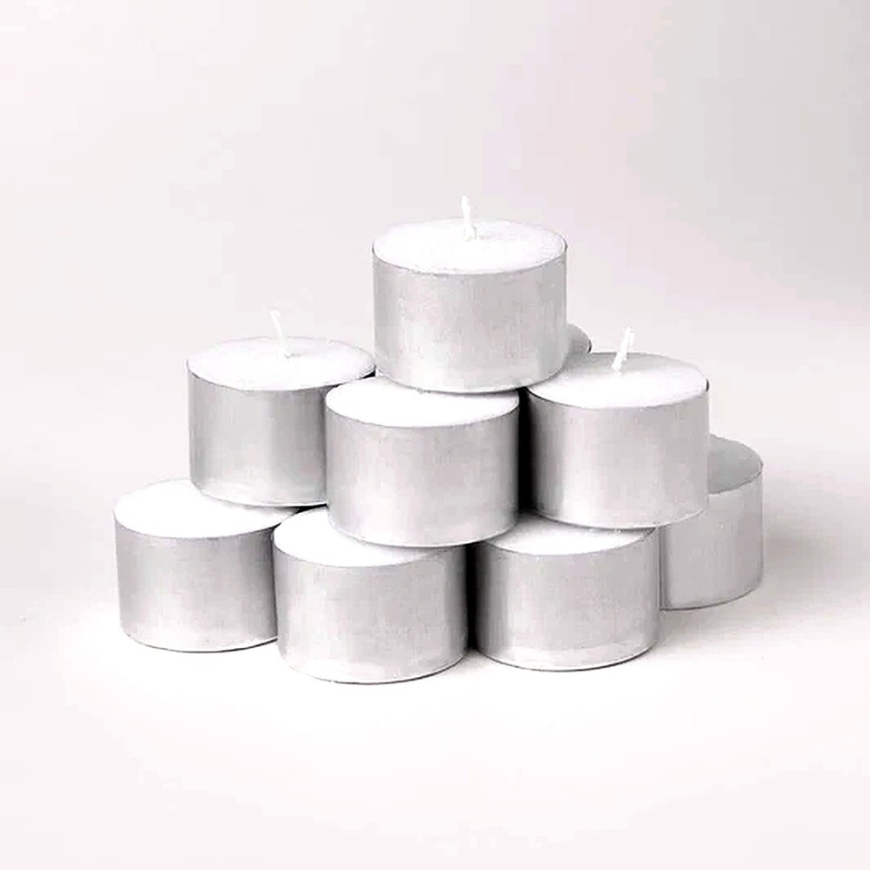 Tea light candle close up white wax aluminium cup detail