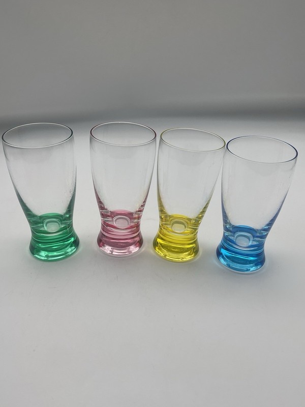Set of four Royal Danube shot glasses with solid colored bases.