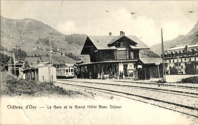 Carte postale Château d'Oex canton de Vaud, gare, grand économies hôtel Beau Sejour - 11121525