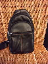 Black Men's Crossbody Sling Bag with Adjustable Strap and Outer Pockets.