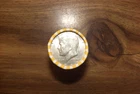 kennedy half dollar roll with a 40% silver 1968 half on end in vV- good cond.