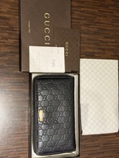 GUCCI GG Leather Round Zipper Wallet Black with gold hardware