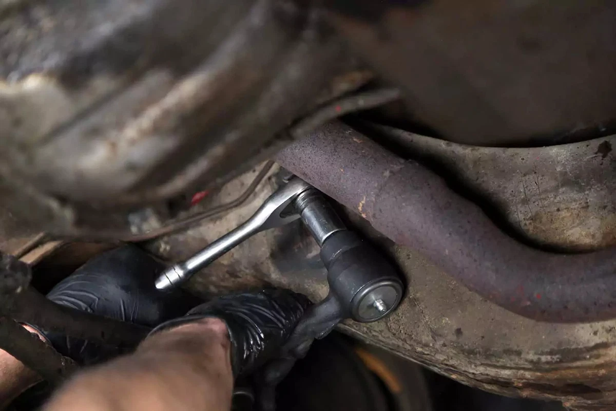 The new castle nut is installed on the frame mount with a socket wrench.