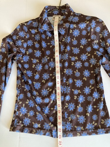 Brown and blue floral County Seat ladies’ shirt size M with long sleeves, shown flat with measuring tape along neckline.