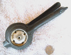 Unusual cast iron lemon squeezer w/white ceramic cup & plunger -later 1800's — photo 2