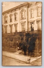RPPC street scene lady man ivy Postcard Real Photo sidewalk vines