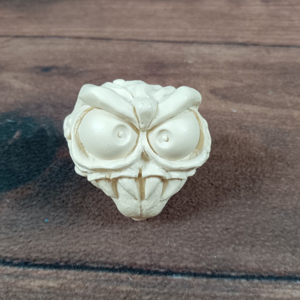 A genuine vintage monster head sculpture — the kind of weird, one-of-a-kind oddity that anchors an entire shelf and makes every guest ask 'where did you GET that?'