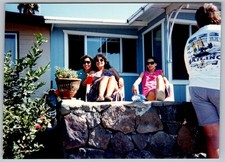 Vtg Color Snapshot Three Women Sitting On Stone Wall Outside Blue House 1990s