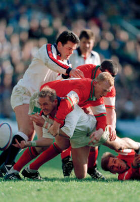 Dewi Morris of England is tackled by Neil Jenkins of Wales dur- Old Rugby Photo