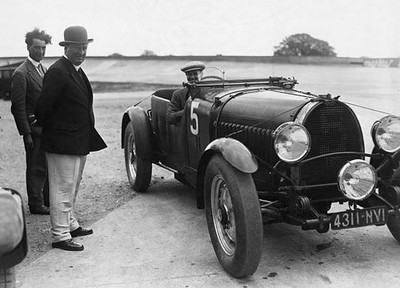 Italian car manufacturer Ettore Bugatti and another man stand next- Old Photo