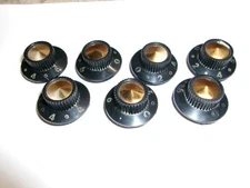 7 VINTAGE BLACK PLASTIC CONTROL KNOBS W/BRASS INSERT.