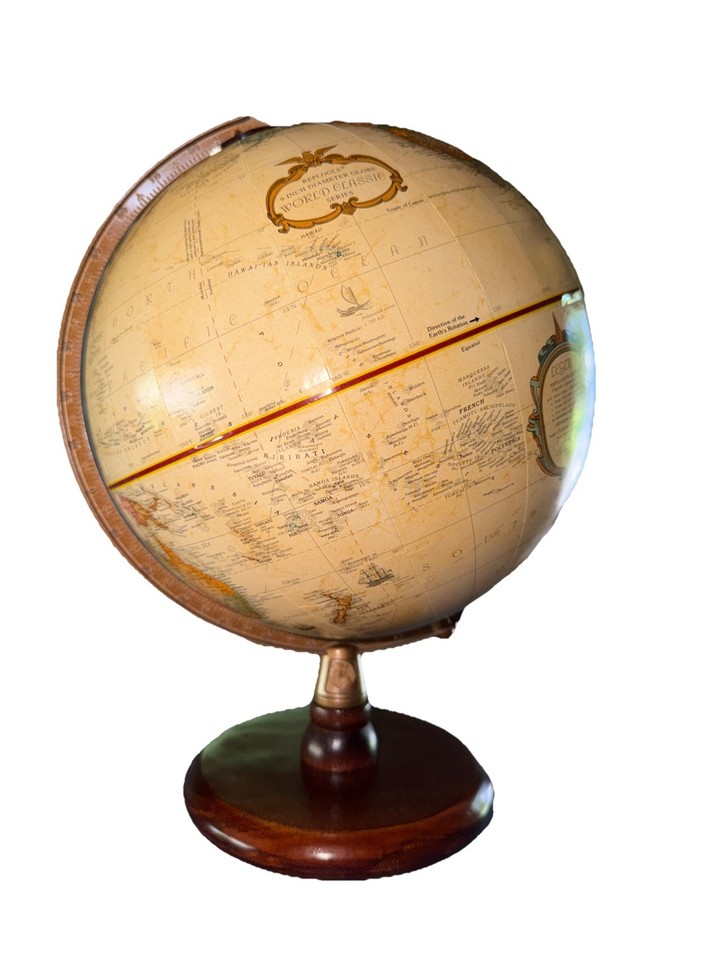 A mint-condition 9" Replogle on a wood base — the perfect compact globe for a reading nook or as a thoughtful Made-in-USA vintage gift.