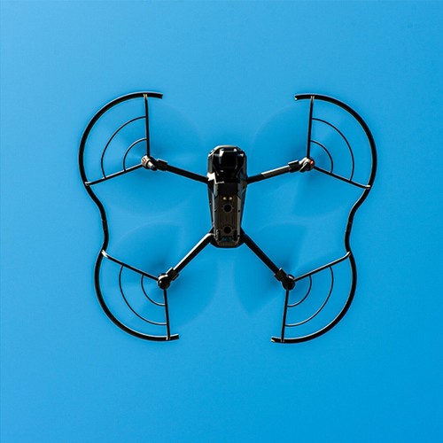 Black Mavic 3 drone with four open propellers guarded by lightweight black and silver fan blades on a blue background.