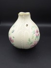Cream round LENOX MORNINGSIDE vase with gold rim, bee, dragonflies, and purple floral accents on black background.
