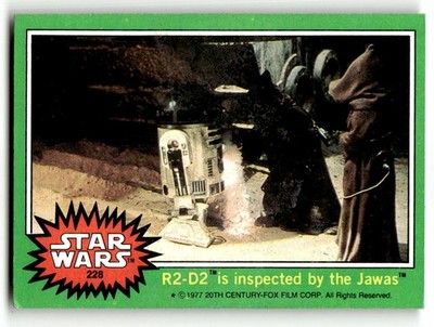 1977 Topps Star Wars #228 R2-D2 is inspected by the Jawas