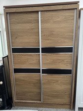 Light oak Effect Sliding Door Wardrobe With Black Decorative Panel
