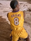 Kobe Bryant 2003 Hallmark Hoop Stars ornament in yellow Lakers jersey with black back number 8 and purple accents.