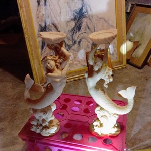 vintage mermaid and dolphin figurine often made from a composite or resin