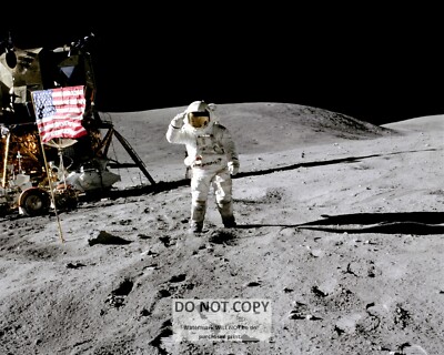 ASTRONAUT CHARLES DUKE SALUTES FLAG DURING APOLLO 16 - 8X10 NASA PHOTO (SP-108)