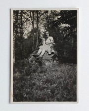 Two friends sitting on a forest rock - old photo snapshot 1932