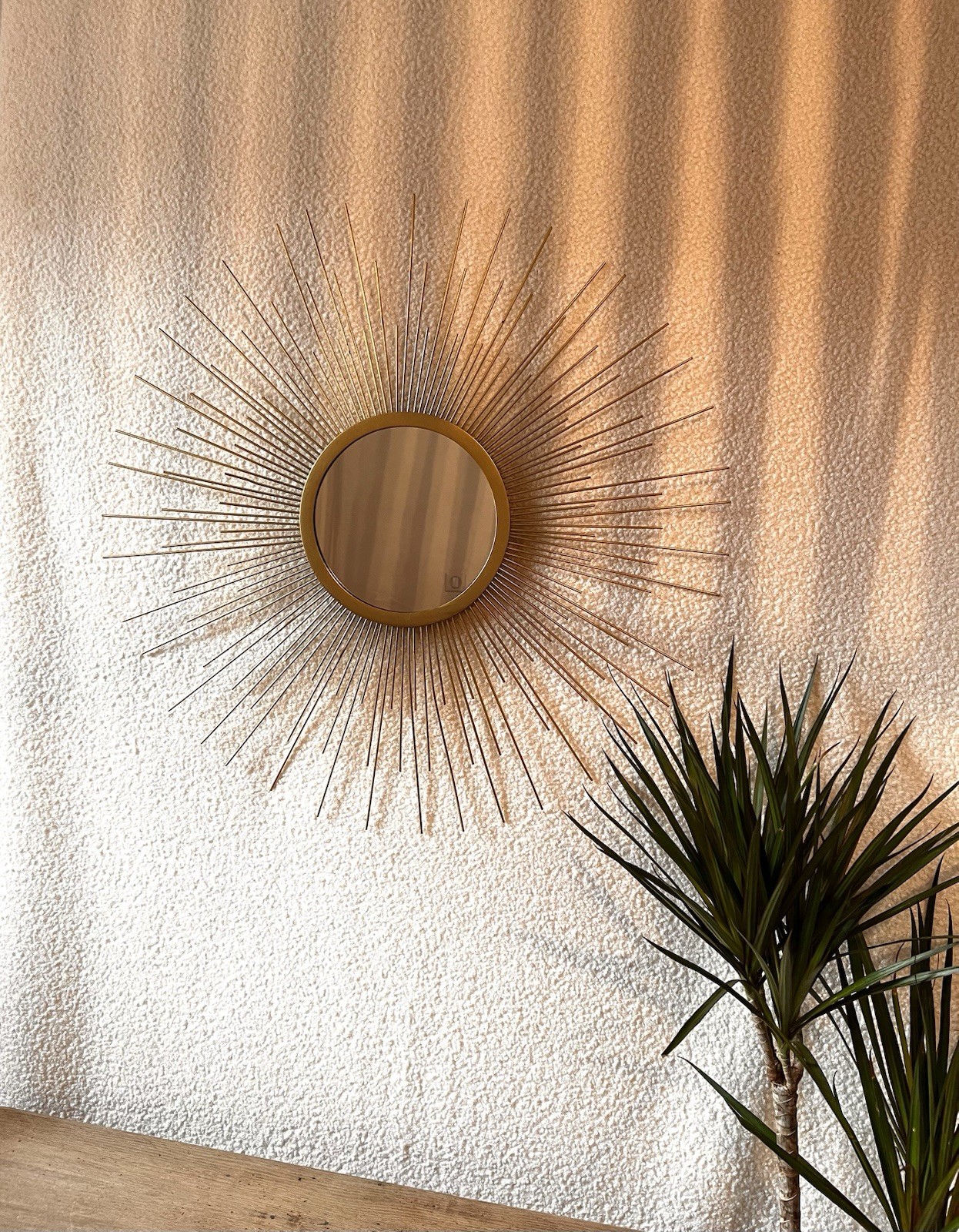 Miroir soleil doré pour agrandir une petite pièce sombre avec style