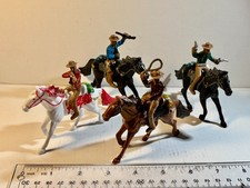 Lot of four 54mm painted Cowboys on horses. Different poses as shown.
