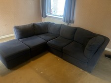 Left hand blue velvet corner sofa from Cousins with large pouffe